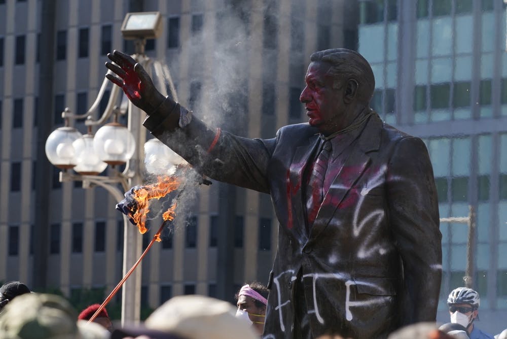 On May 30, protesters vandalized the statue of Frank Rizzo, burning an American flag that they had attached to it. Credit: Chase Sutton